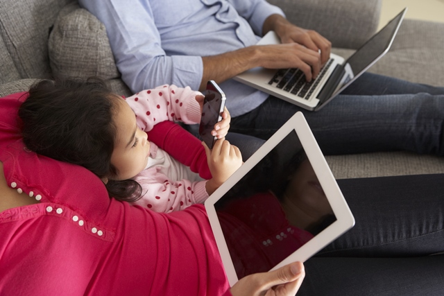 Family with laptop, tablet and smartphone