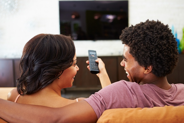 Heterosexual couple watching TV