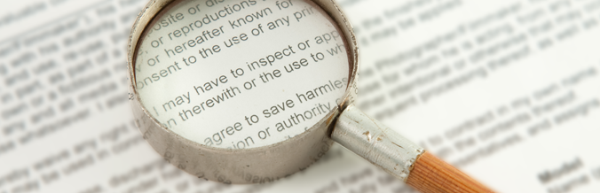 Magnifying glass close up on a contract's text