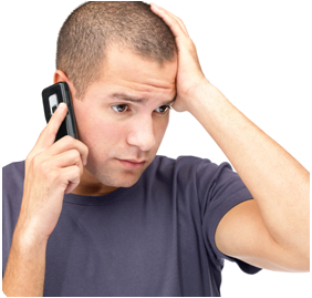Picture of a man holding his head in his let hand while he holds a phone in his right hand