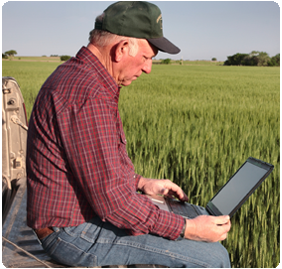 Picture of farmer using a laptop