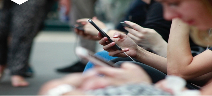 Person in crowd looking at mobile phone