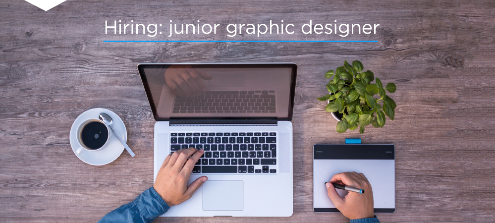 Image of a person using a laptop with a drawing tablet to their right. Text reads: hiring: junior graphic designer