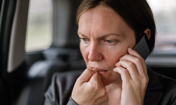 Anxious looking woman on phone