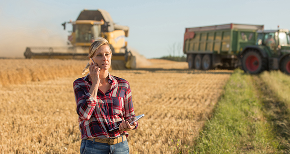 Country woman outstanding in her field on phone