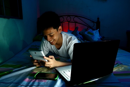 Boy using tablet, laptop and smartphone