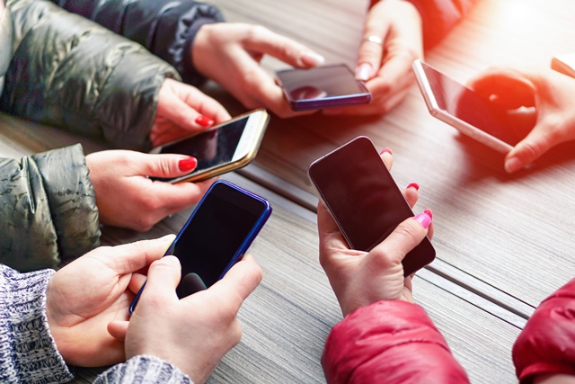 Group of people holding smartphones