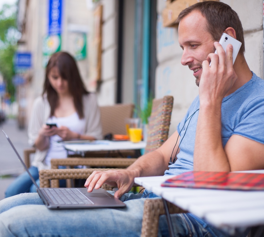 Man using smartphone and laptop