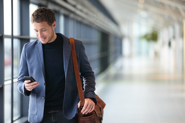 Man using mobile phone at airport