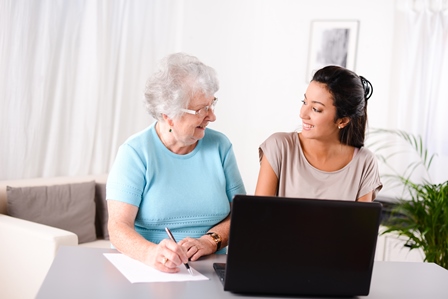 Two women using laptop