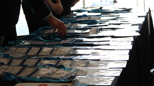 Conference name tags laid out on registration desk