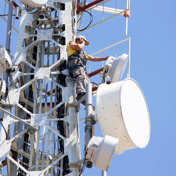Technician repairing a mobile base station tower
