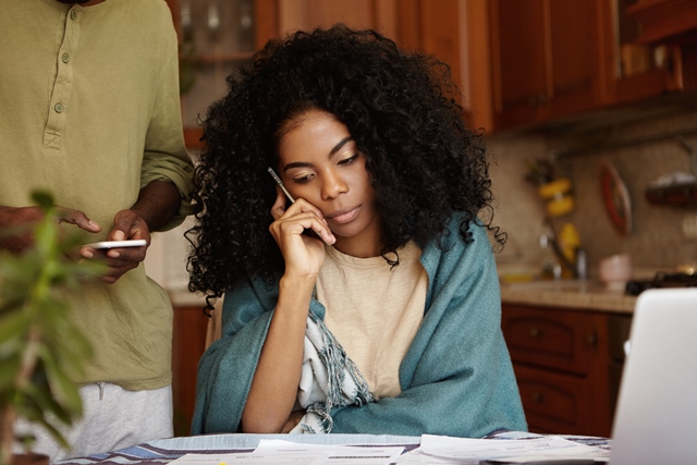 Woman sitting at desk talking on mobile phone