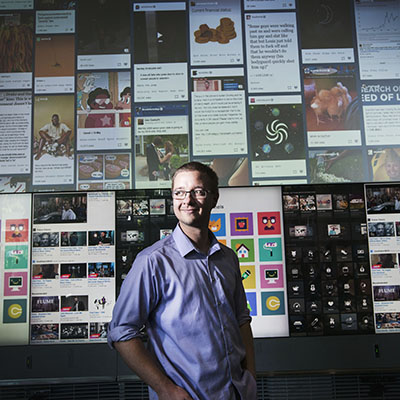 Man standing in front of media wall