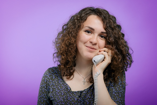 Woman talking on landline phone