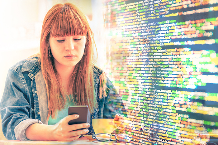 Concerned red-headed young woman looks at phone, she is backgrounded with streams of personal data