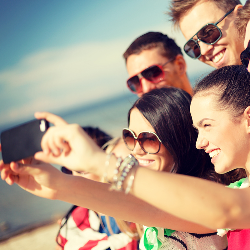Group of friends taking selfie photo on phone