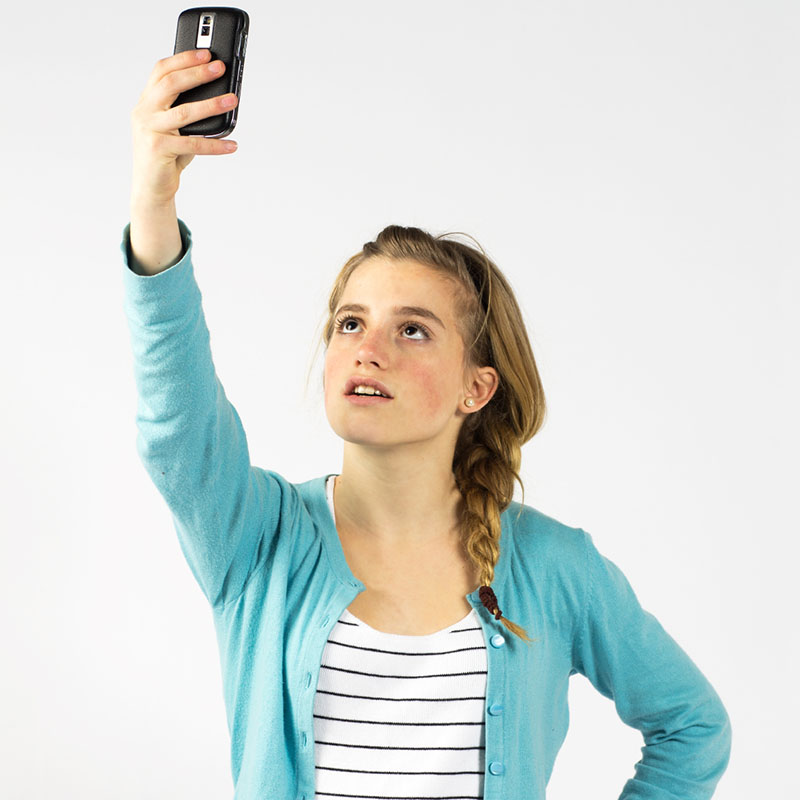 Woman holding up phone looking for mobile reception