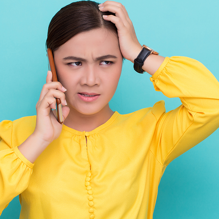 Confused consumer talking on phone