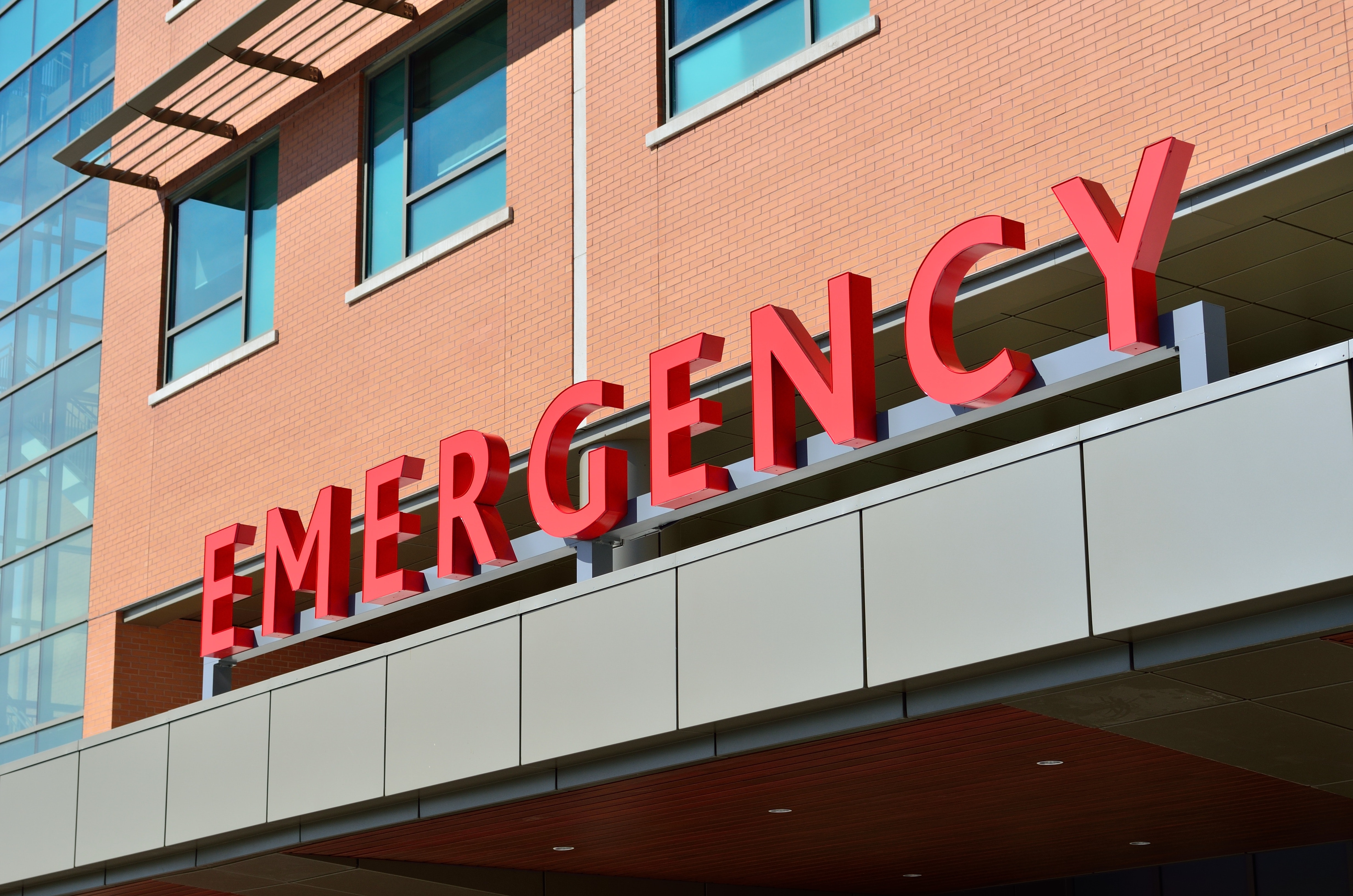 Brick building with EMERGENCY sign 