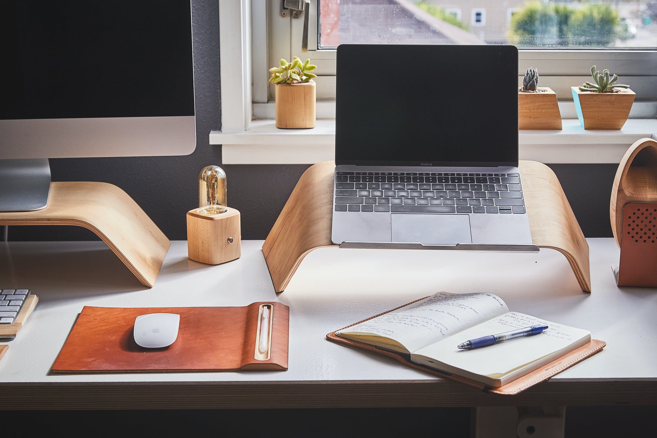 An image of a home office set up, along with a desktop computer, a laptop and a mouse. 